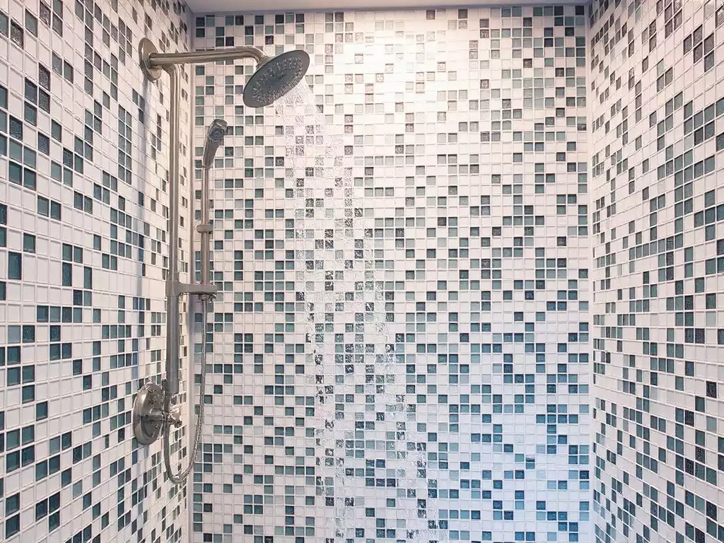 Modern bathroom shower with mosaic tiles, bright and clean, showing water resistance and a sleek design, no text, no words, no typography, clean image